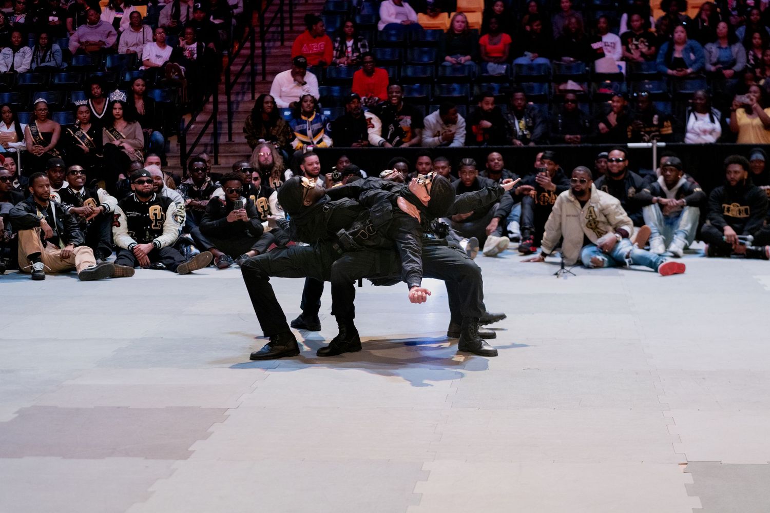 Large crowd gathered on a floor in an indoor space.