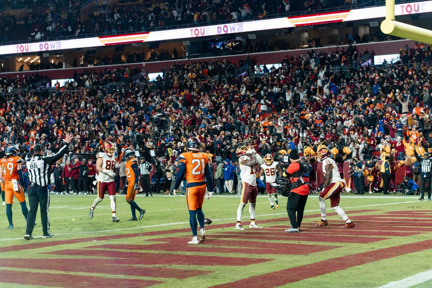 Stadium field goal attempt with players lined up during a crucial game moment.