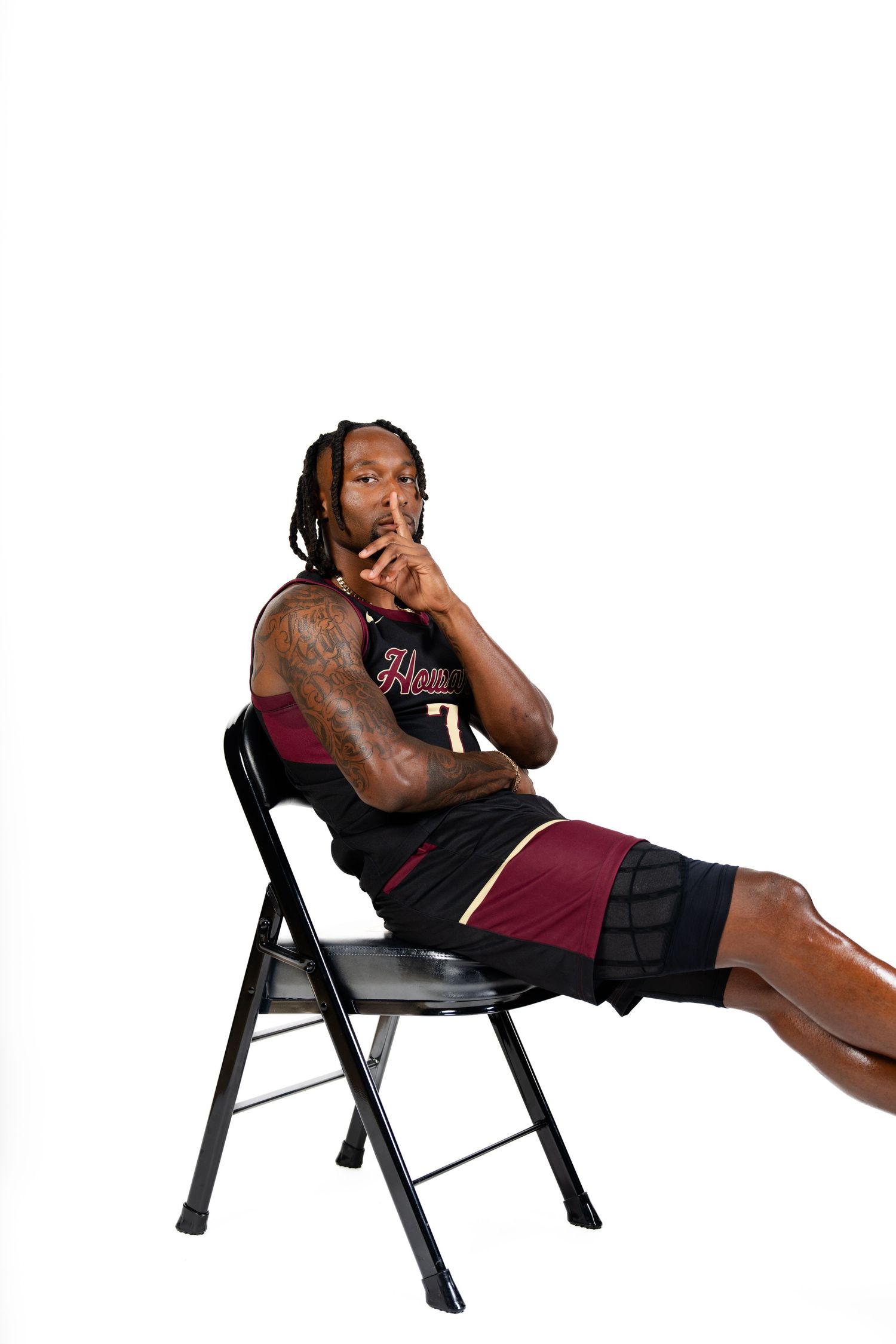 Athletic figure demonstrating various poses on a black folding chair.