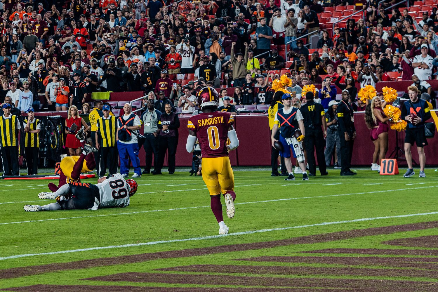 Wide angle view of a football stadium field during a professional game.