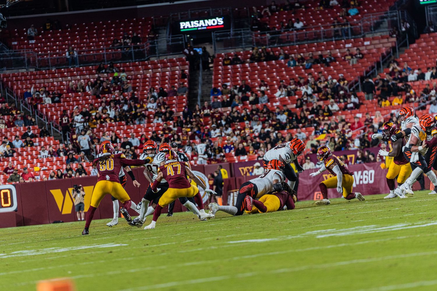 Wide panoramic view of a football stadium during a professional game.