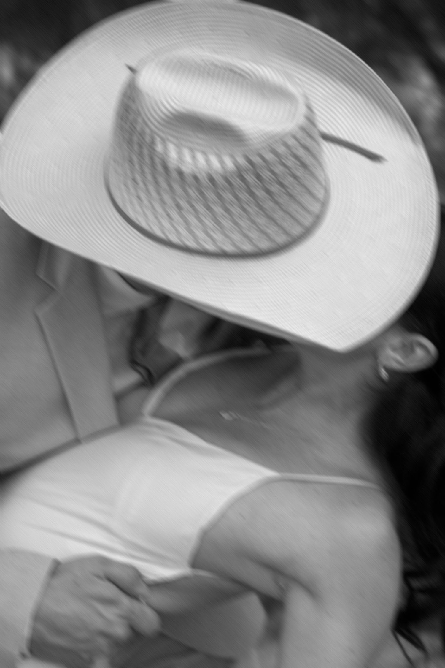 Black and white series showing motion of cowboy hat in dramatic lighting.