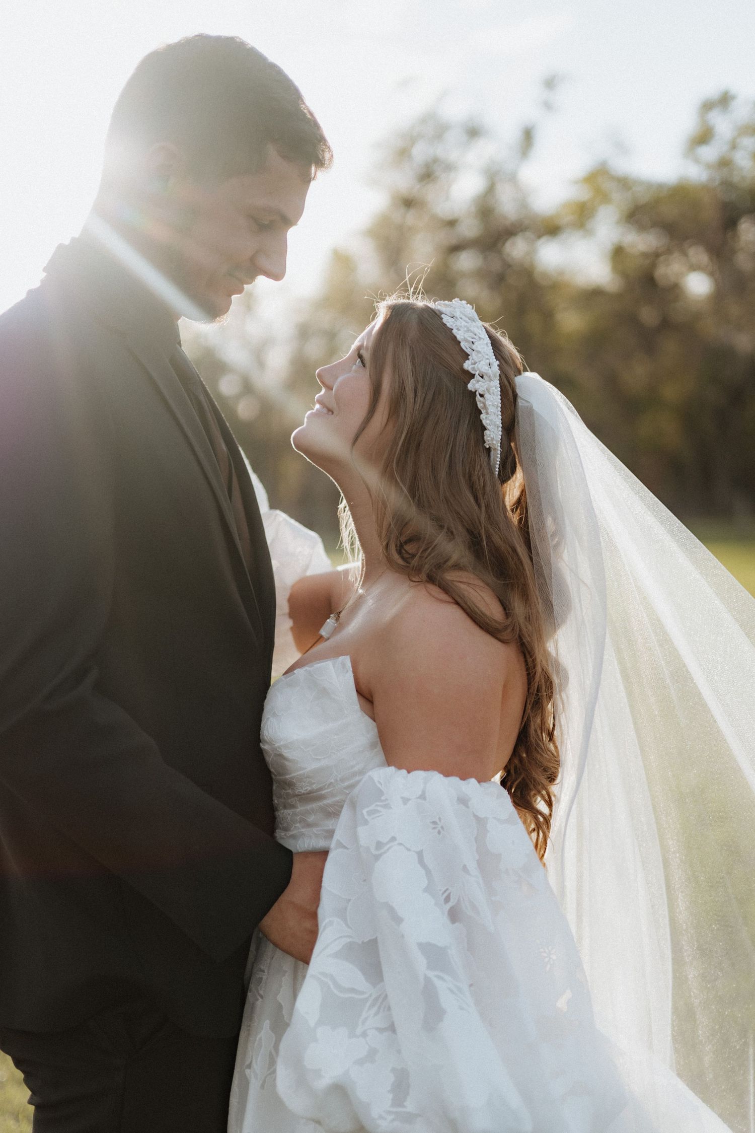A romantic backlit wedding portrait sequence showing the couple in an intimate outdoor setting.