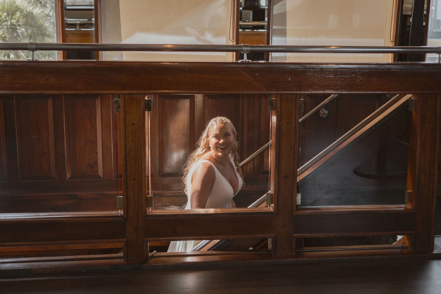 A vintage wooden window frame creates a rustic backdrop for wedding photography.