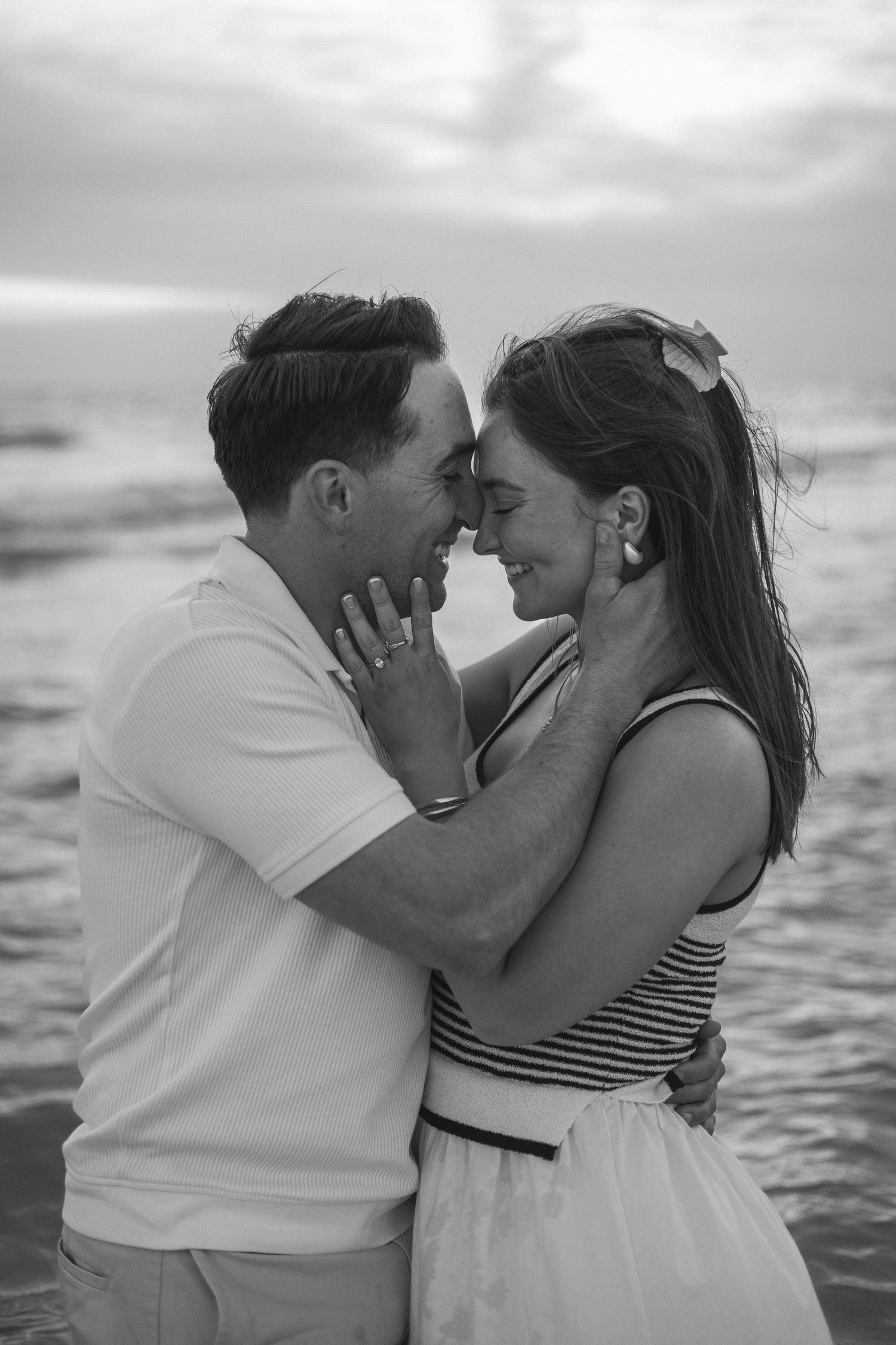 Black and white romantic portrait by the water.
