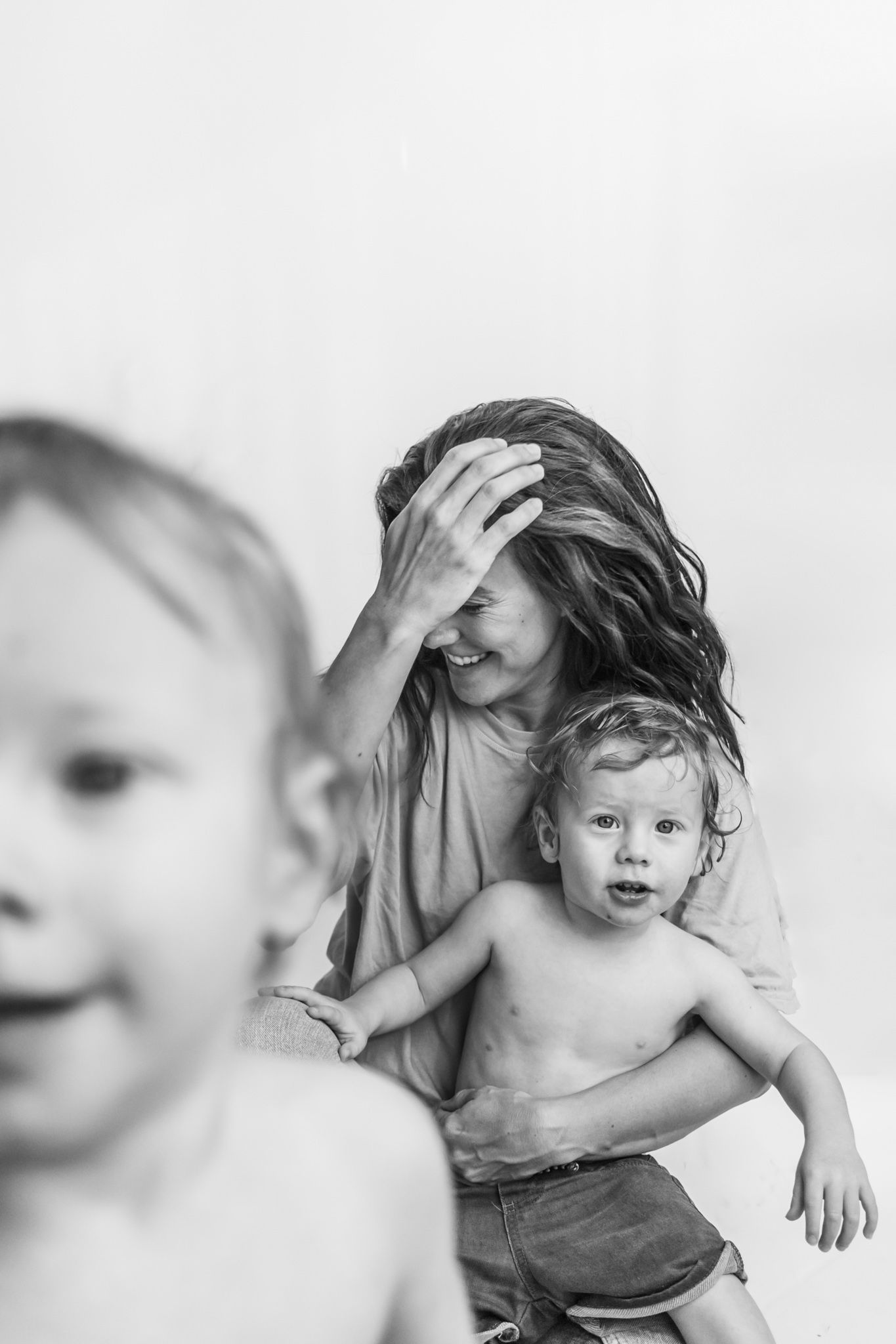 Artistic black and white portrait series showing intimate family moments.
