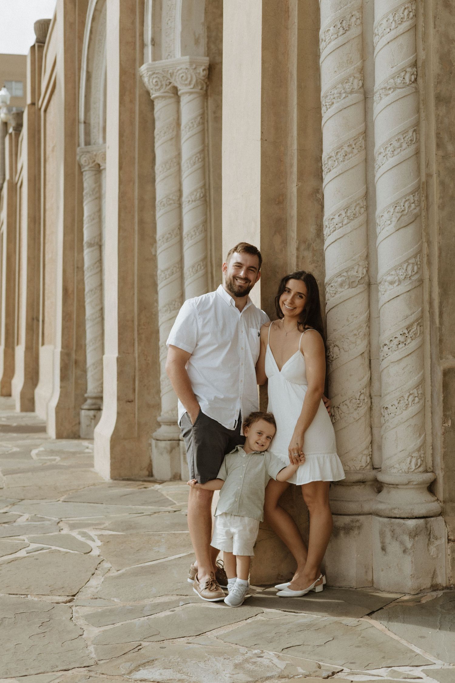 Artistic photoshoot among classical stone columns.