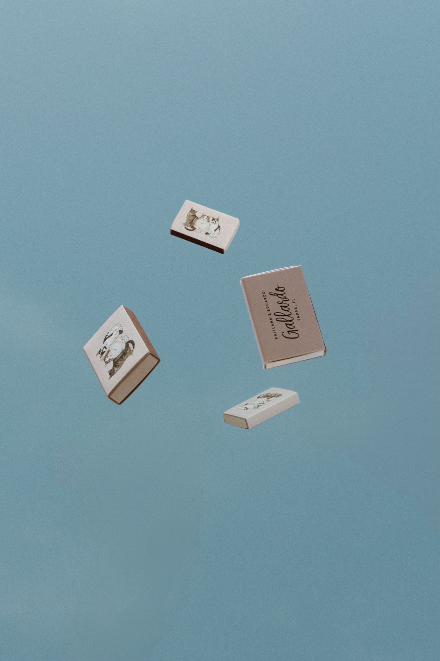 Multiple playing cards floating against a light blue sky background.