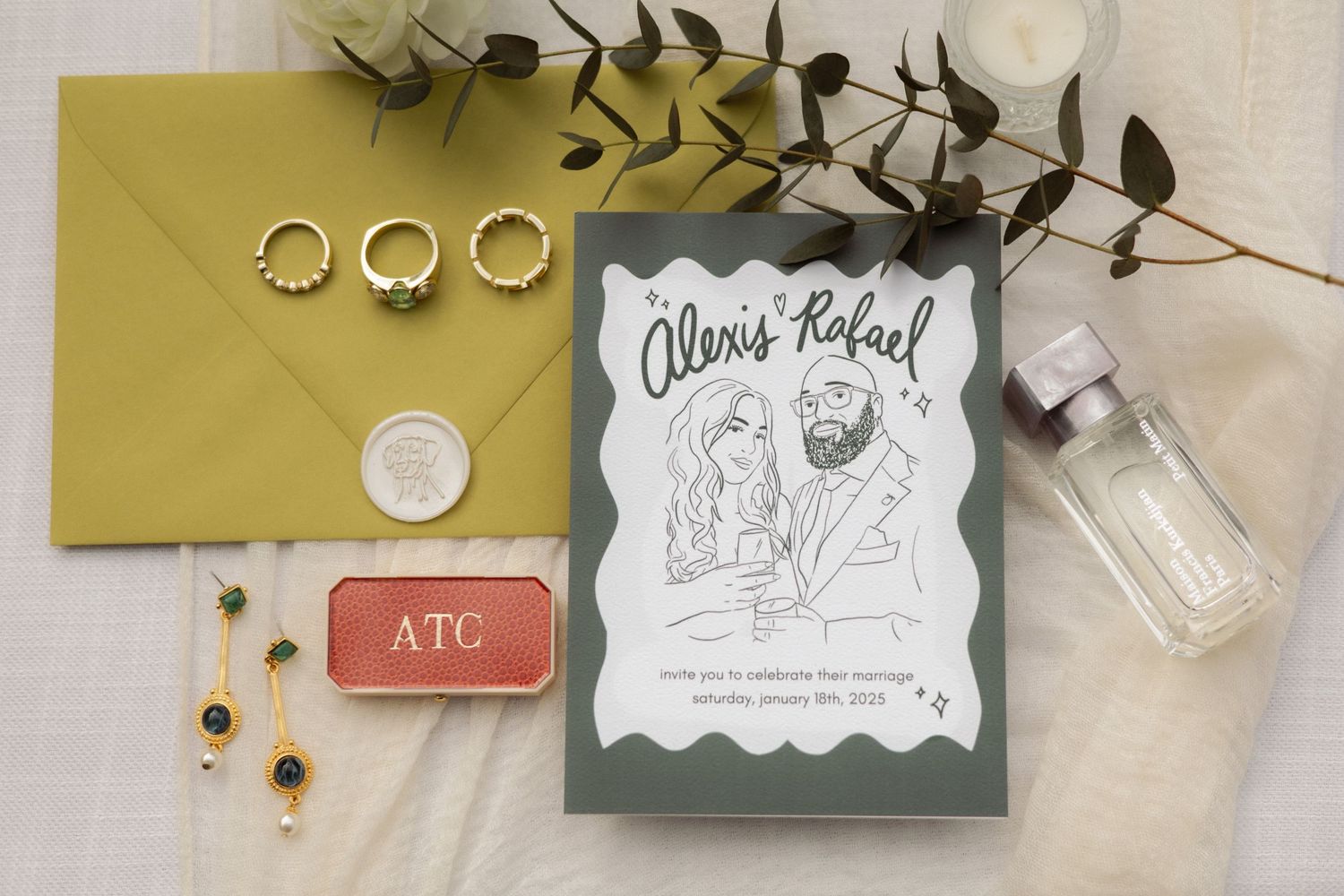 Wedding invitation and rings styled with gold envelope and eucalyptus branches.