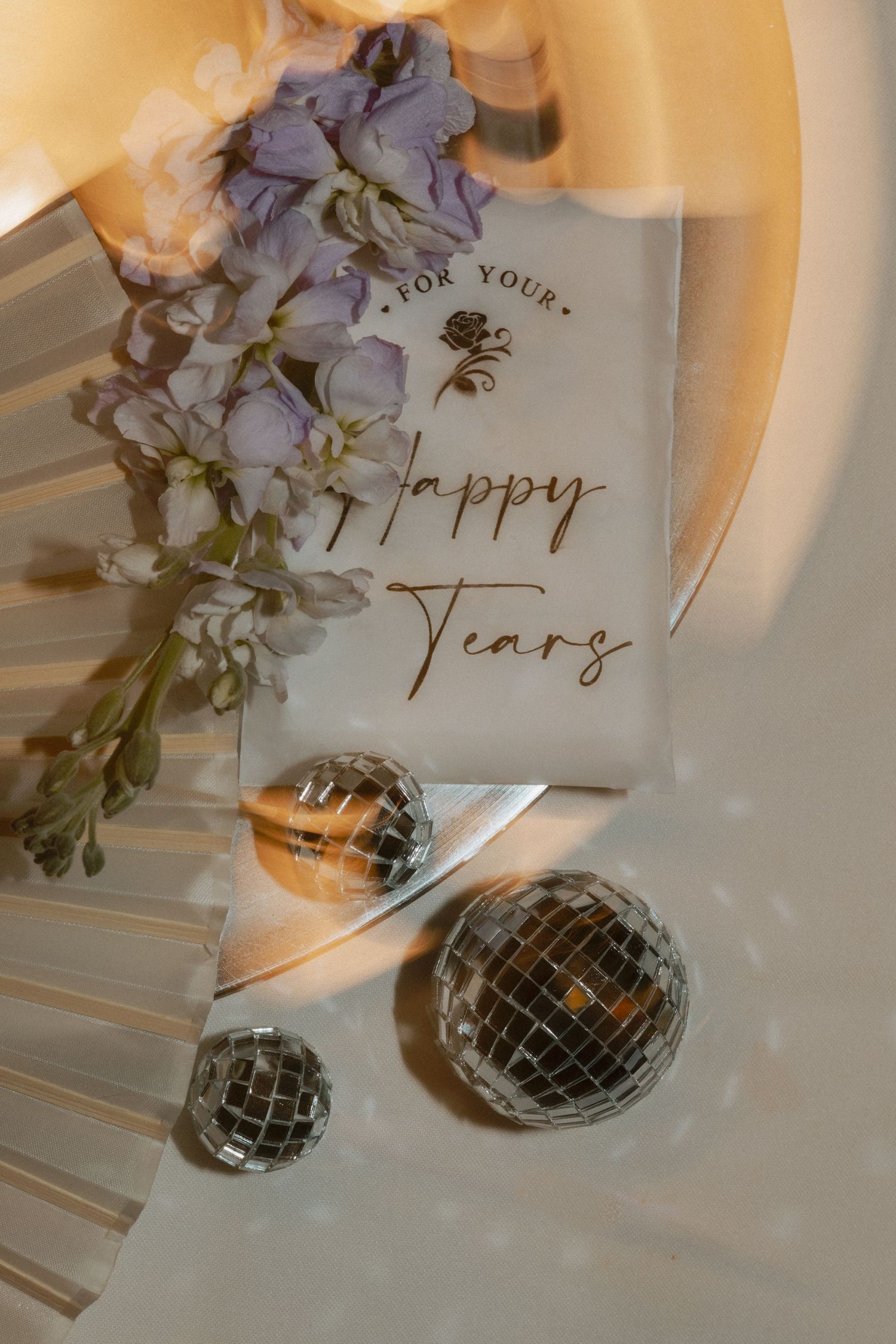 Decorative wedding detail with mirror disco balls and 'Happy Years' text in elegant script.