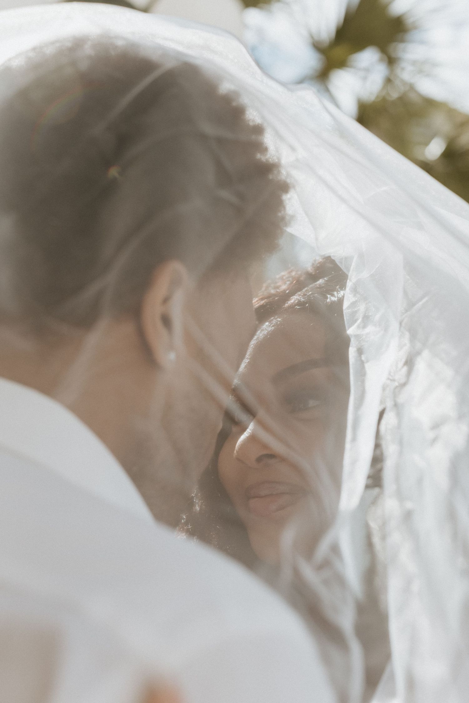 A romantic wedding veil blows in the breeze creating an ethereal effect in a series of soft, dreamy photographs.