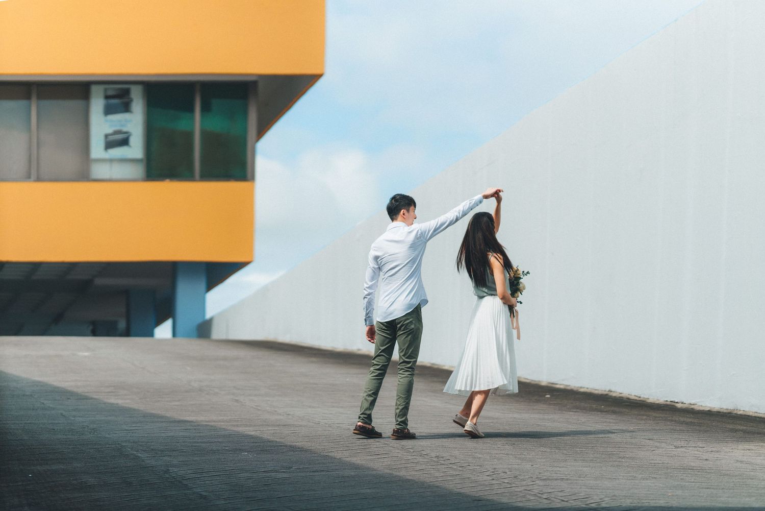 A series of minimalist architectural photos showing people in white clothing against geometric building walls.