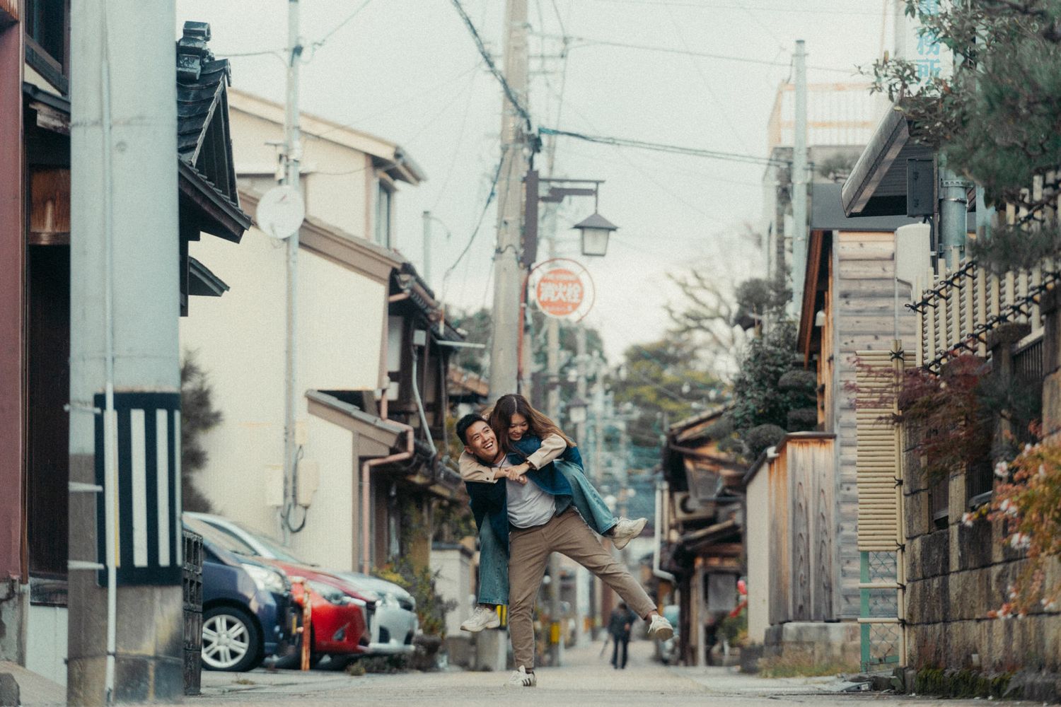 Empty street view of a traditional Japanese neighborhood with power lines and buildings.