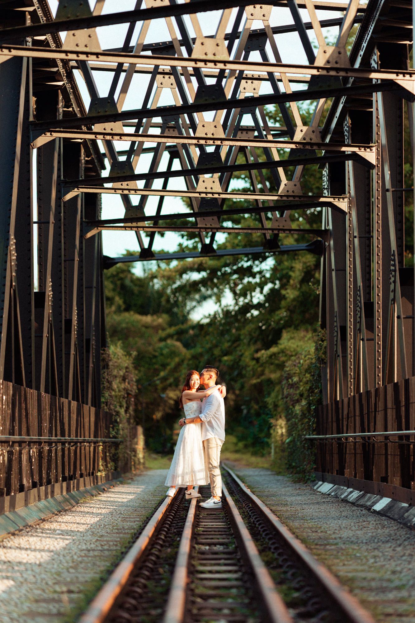 Vintage iron railway bridge with geometric trusses and wooden planks.