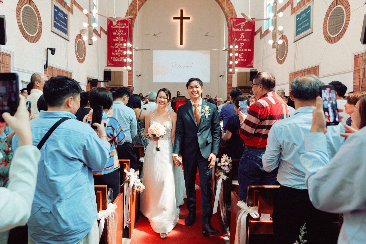 Wedding congregation standing and participating in church service.