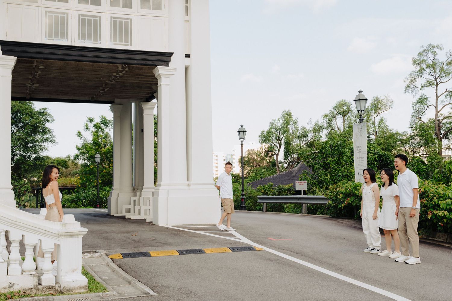 A sequence of wedding photos showing a couple walking and posing near white pillars and architectural elements outdoors.