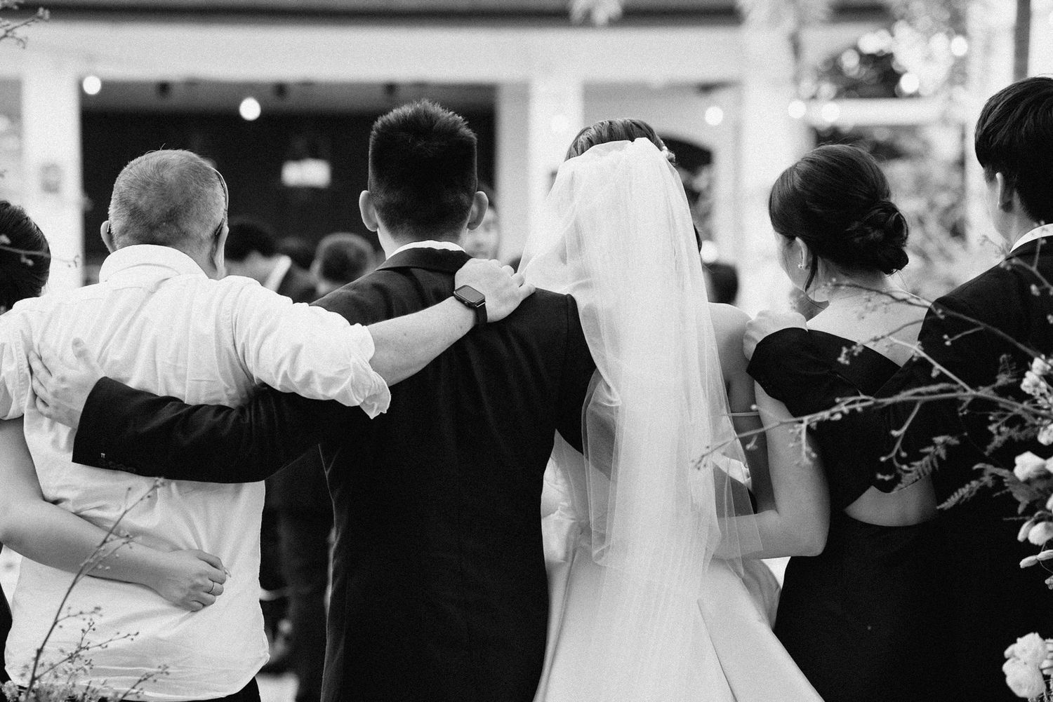 A series of black and white wedding photos showing couples dancing and embracing during a reception celebration.