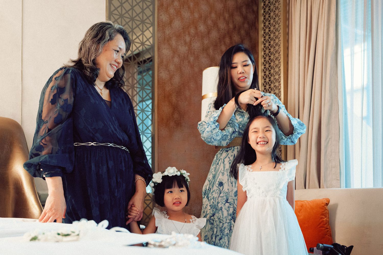 Wedding preparation scene in an elegant hotel room with patterned wallpaper.