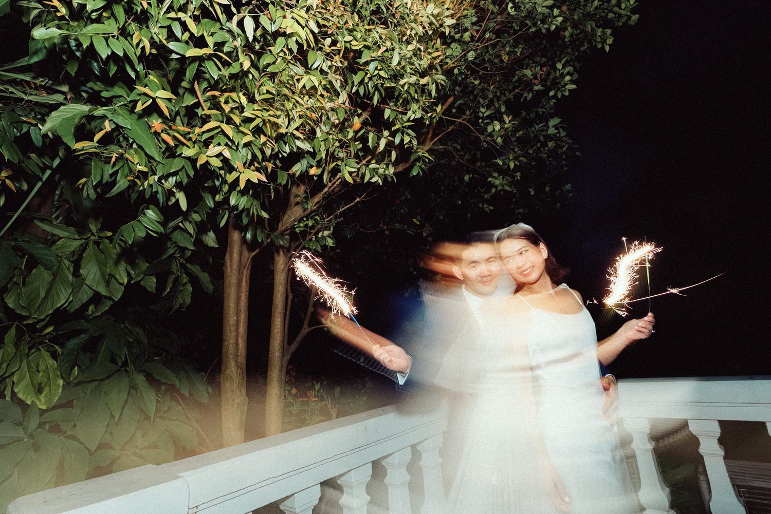 A series of dimly lit outdoor wedding photos showing couples dancing and celebrating at a nighttime reception.