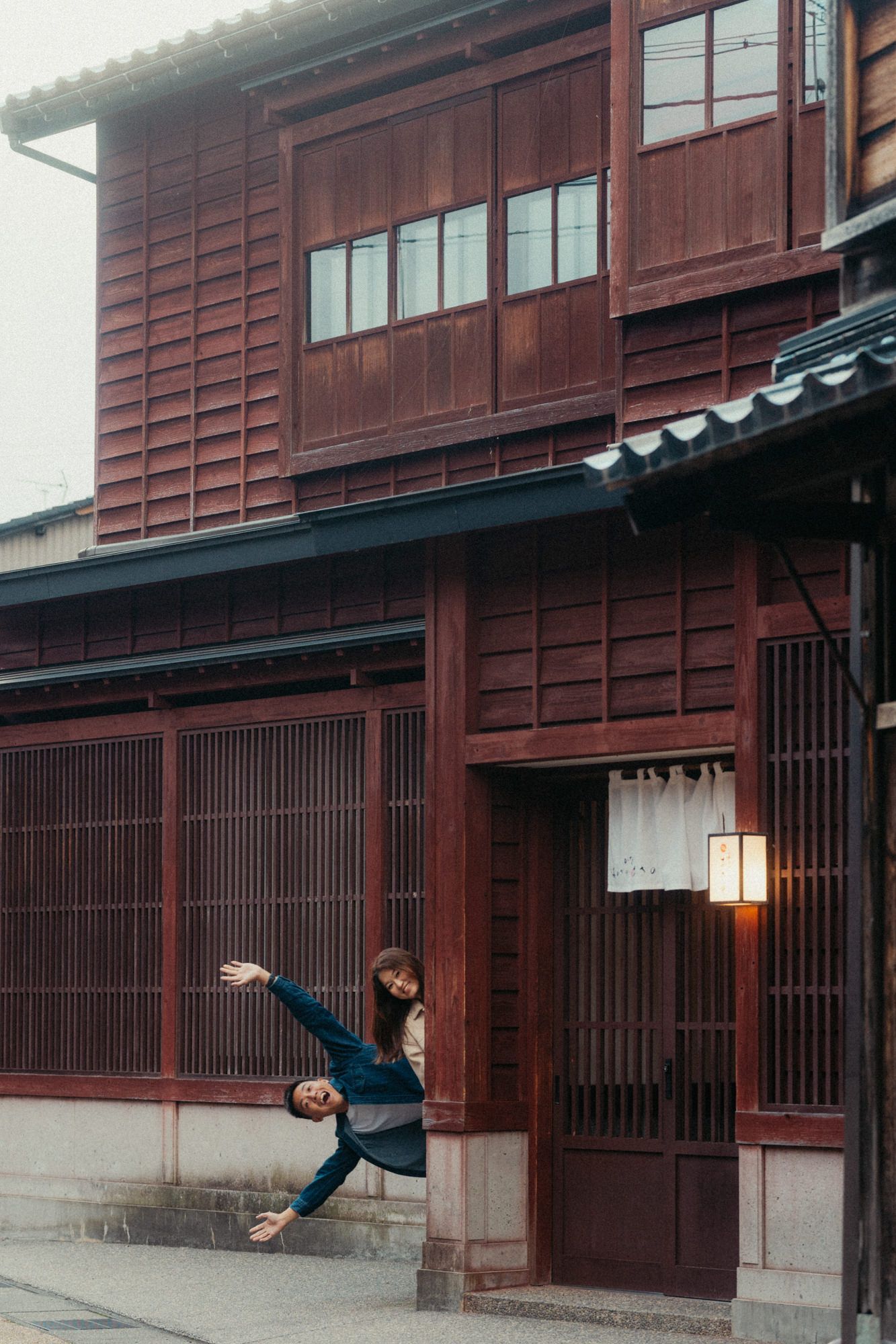 Historic Japanese wooden buildings with traditional architectural details and sliding doors.