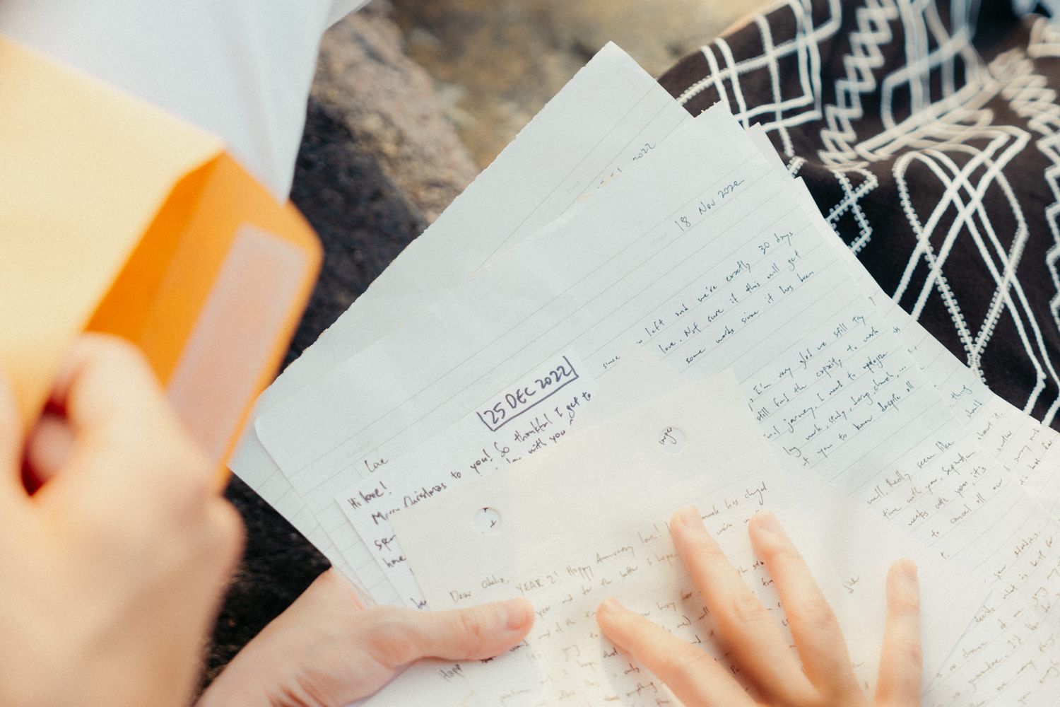 A couple reads handwritten notes together during a romantic moment.