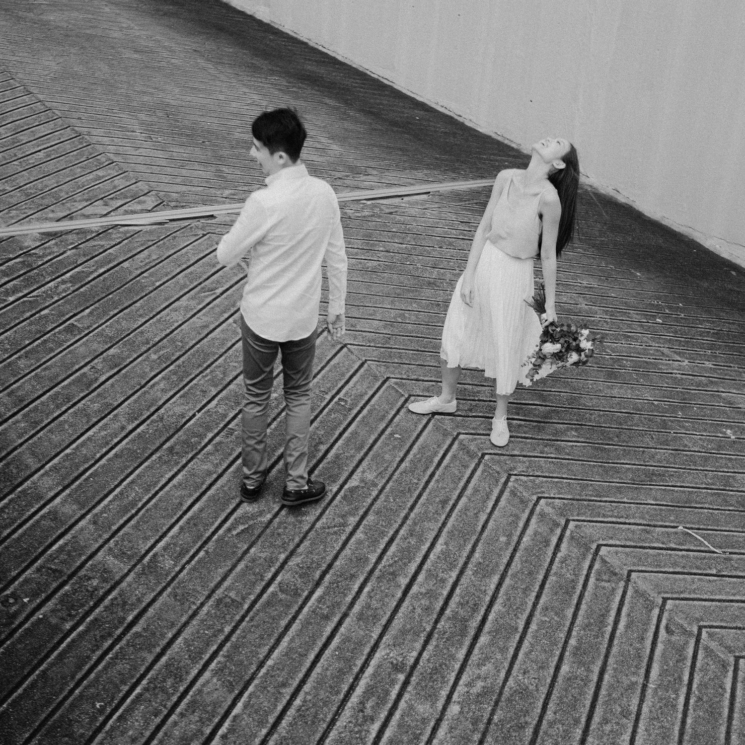 A sequence of black and white photos showing people walking down wooden stairs on a boardwalk.