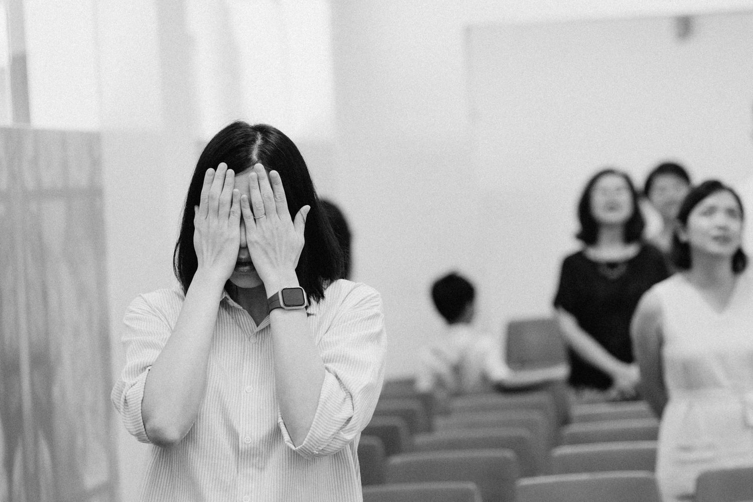 Emotional reactions of wedding guests during ceremony in church setting.
