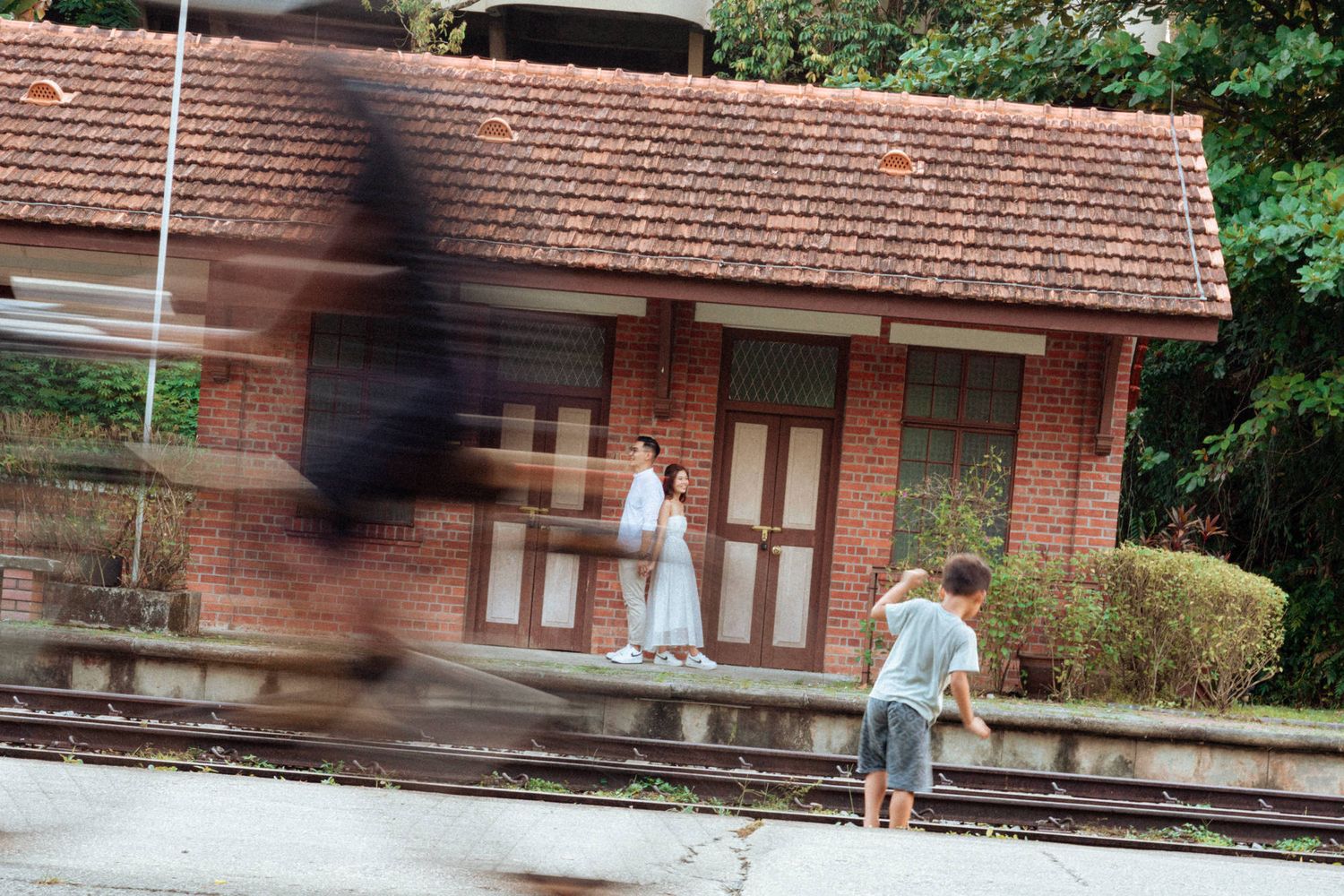 Motion-blurred shot of brick building exterior with covered walkway.