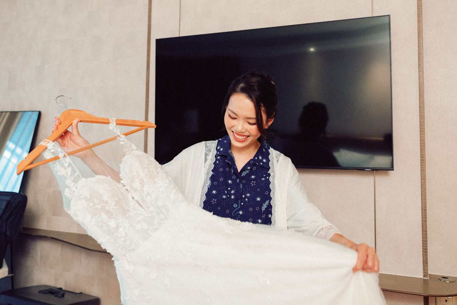 Wedding dress being prepared and steamed in a hotel room.