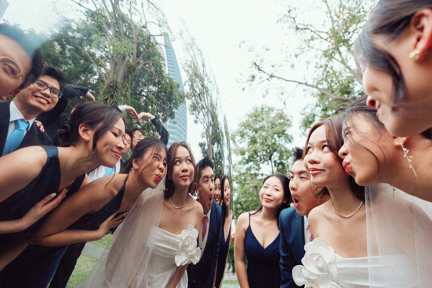 Candid moments of laughter and joy shared during outdoor wedding celebration.