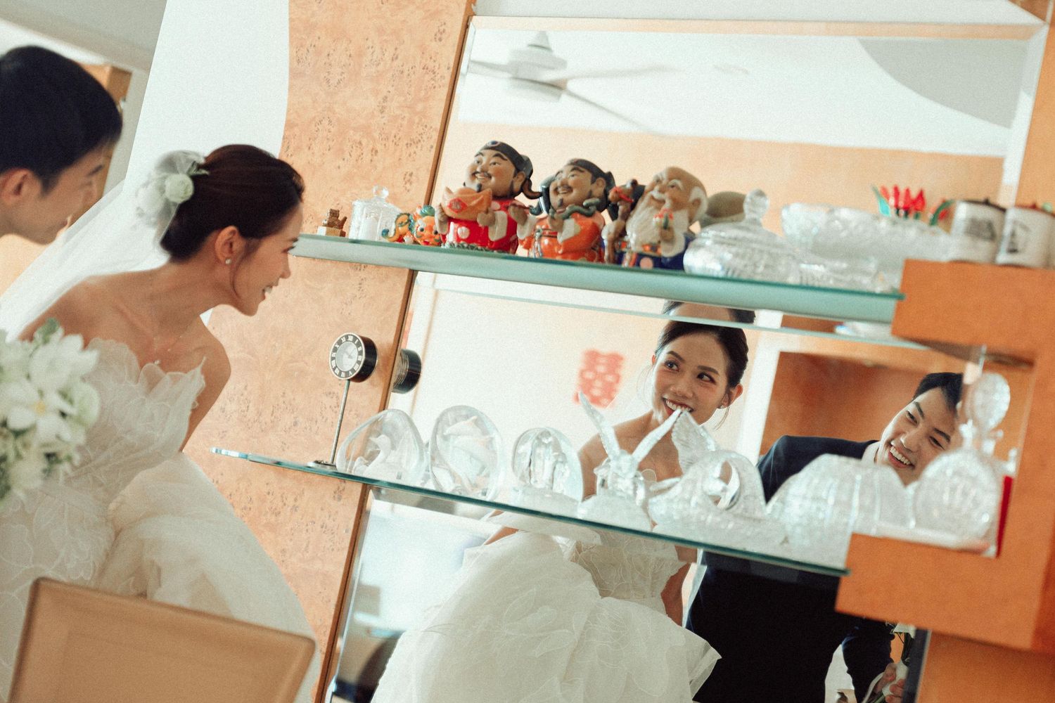 Wedding celebration scene with guests and decor in a peach-toned interior.