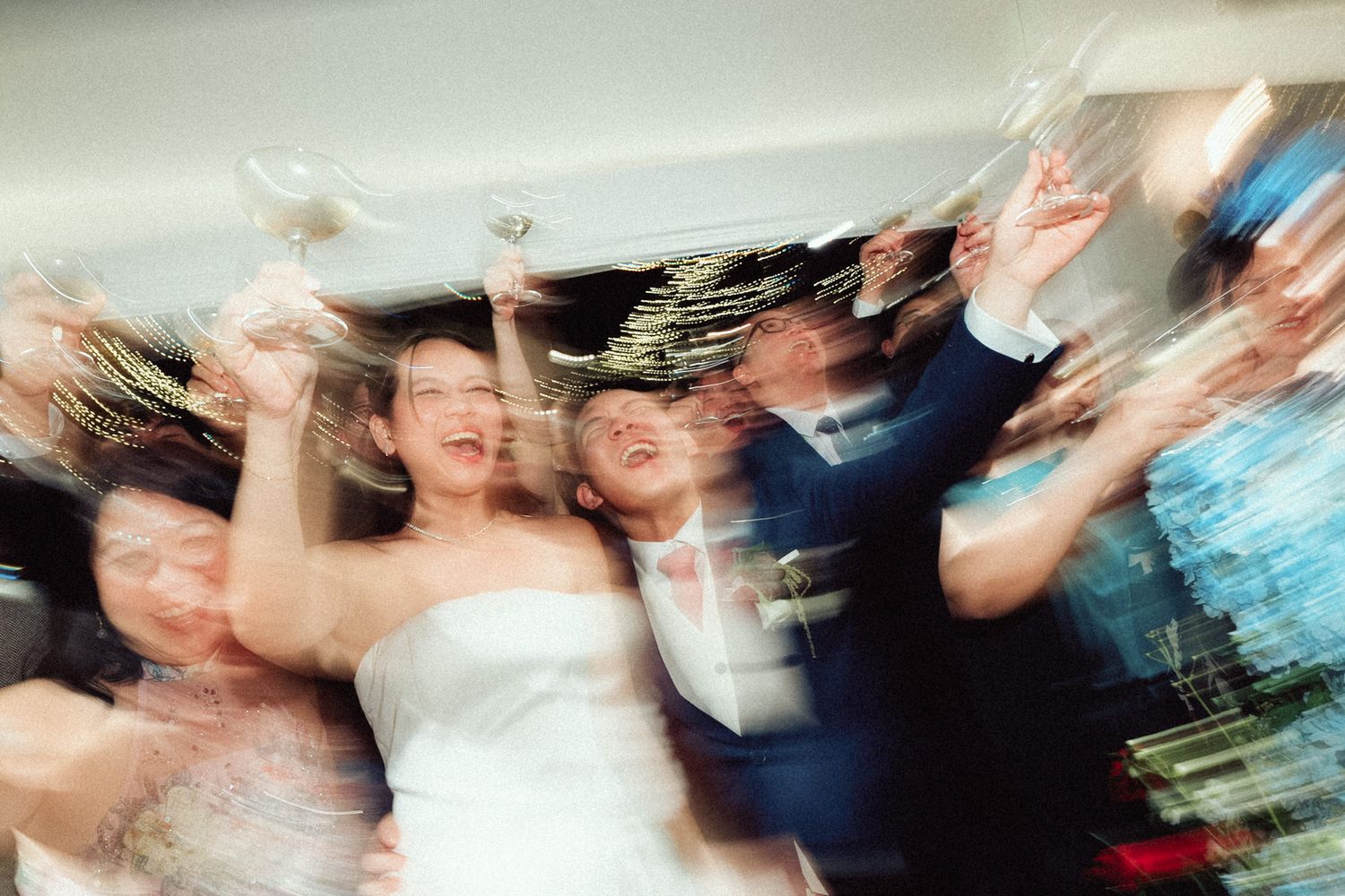 Abstract motion blur of people dancing and moving creates a dynamic pattern of colors and shapes in a party setting.