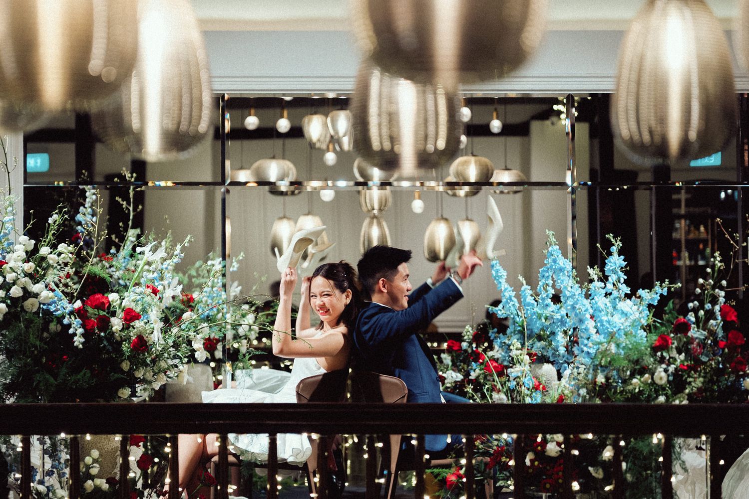 Elegant banquet hall decorated with twinkling lights and floral arrangements for an evening celebration.