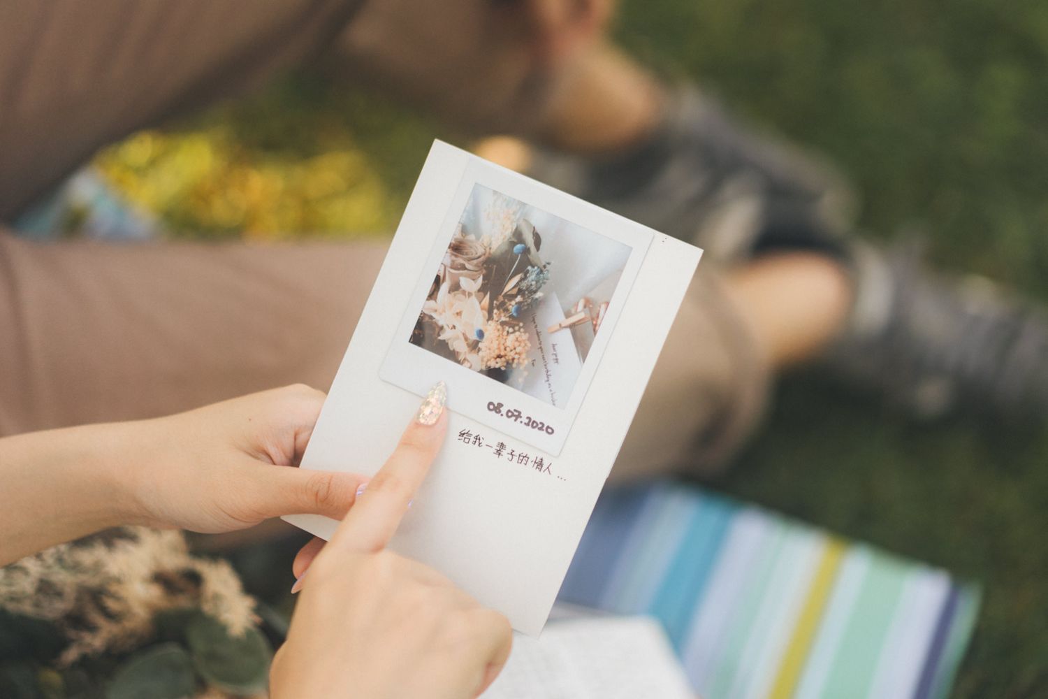 A series of hands holding polaroid style photographs in outdoor settings with natural lighting and blurred backgrounds.