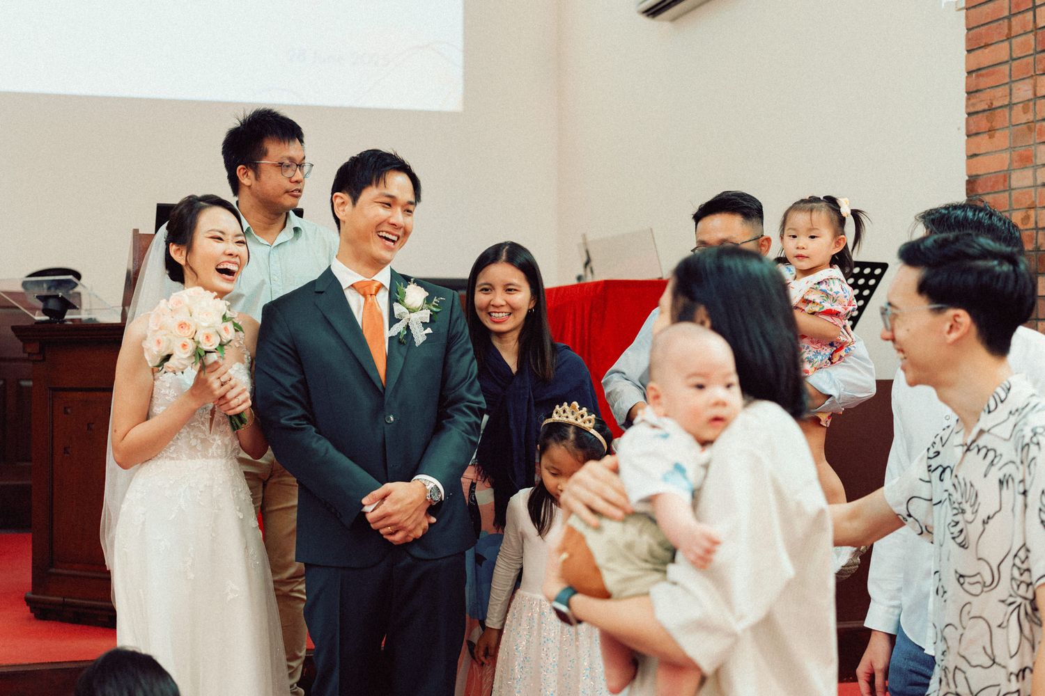 Wedding celebration candid moments captured inside brick church with guests and wedding party.
