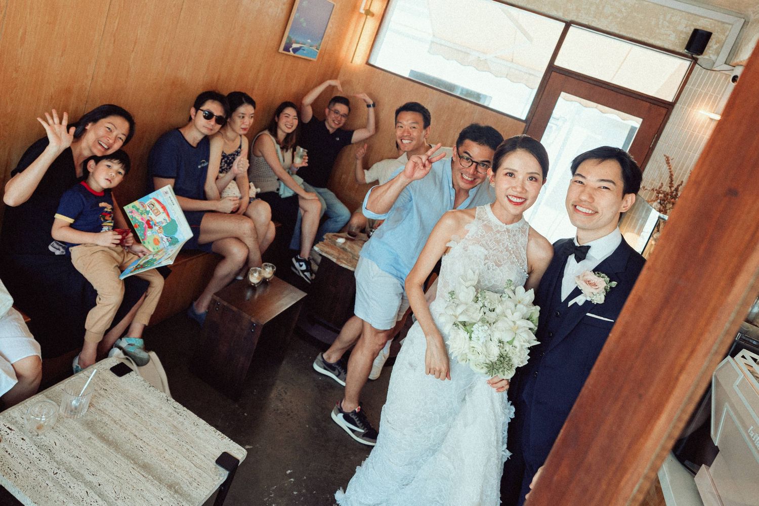 Wedding guests enjoying festivities and socializing at an indoor reception.