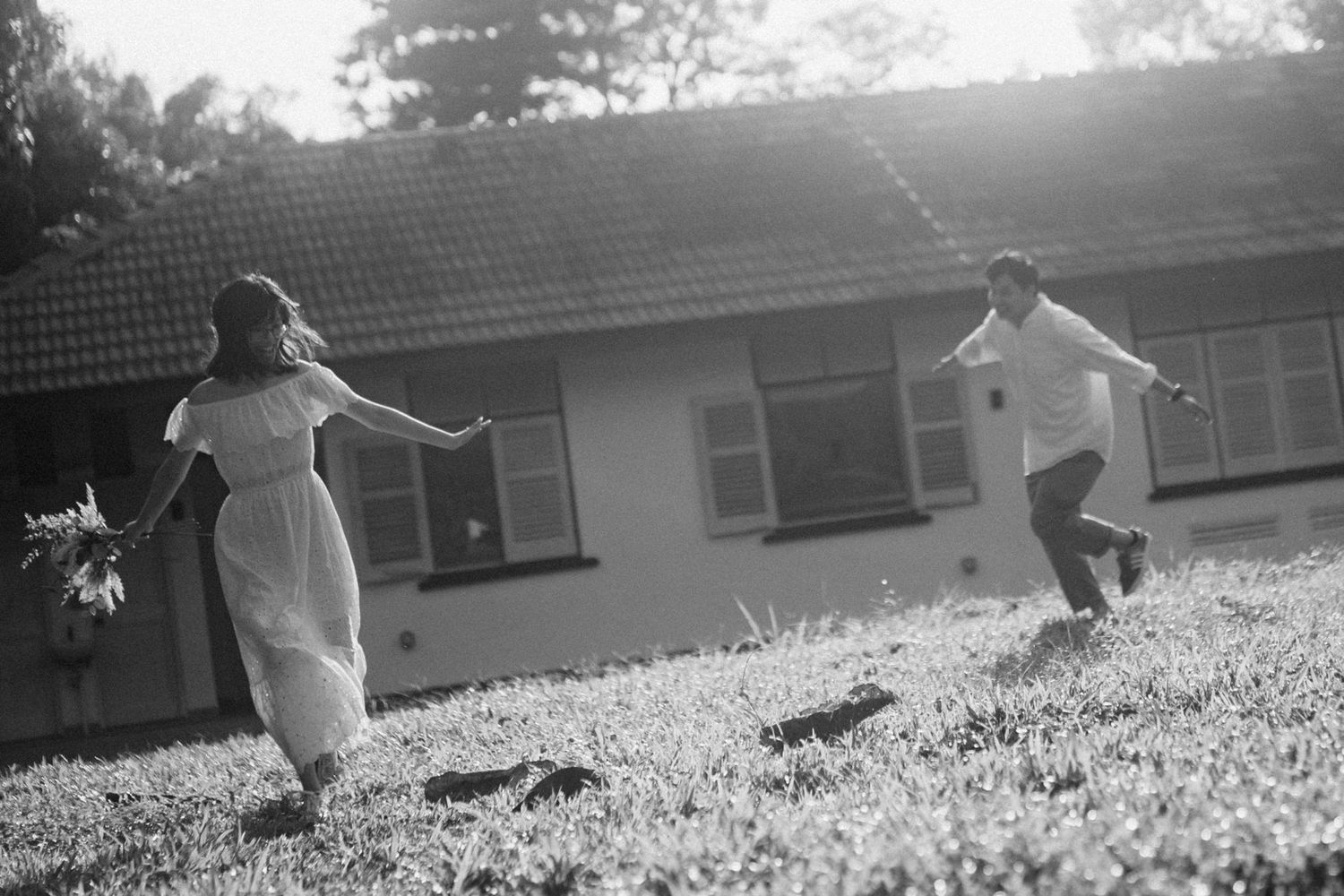 Silhouetted figure running across a grassy hillside at sunset creating a dynamic motion scene.