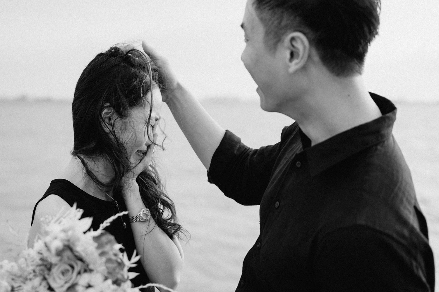 A black and white collage of romantic wedding photos showing intimate moments between a couple at the beach.