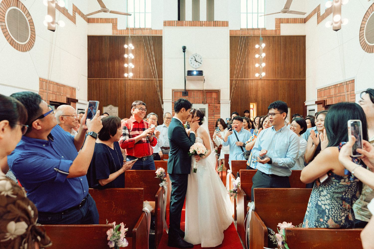 Church sanctuary filled with wedding guests during ceremony celebration.