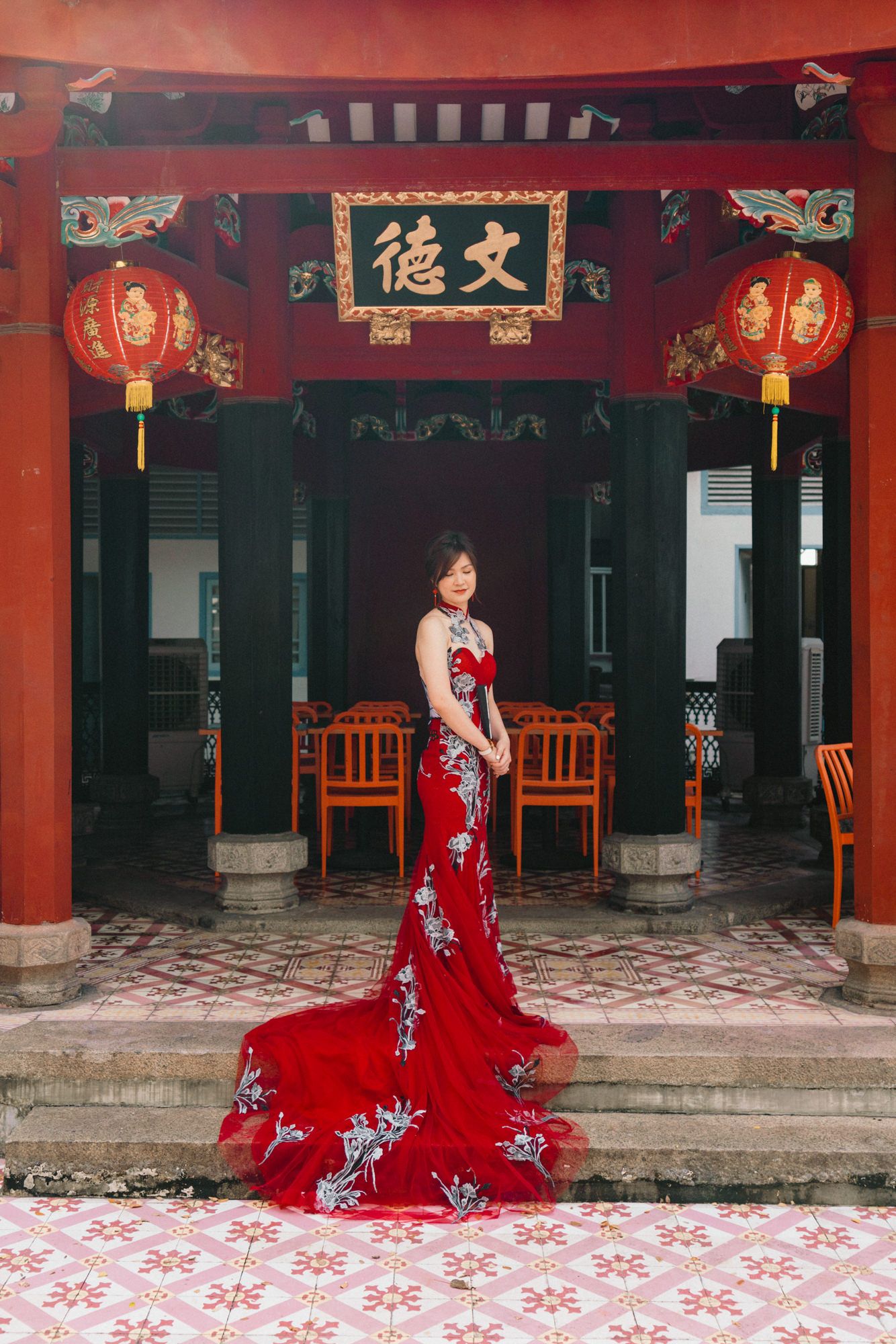 Traditional Chinese courtyard with red walls and decorative lanterns.