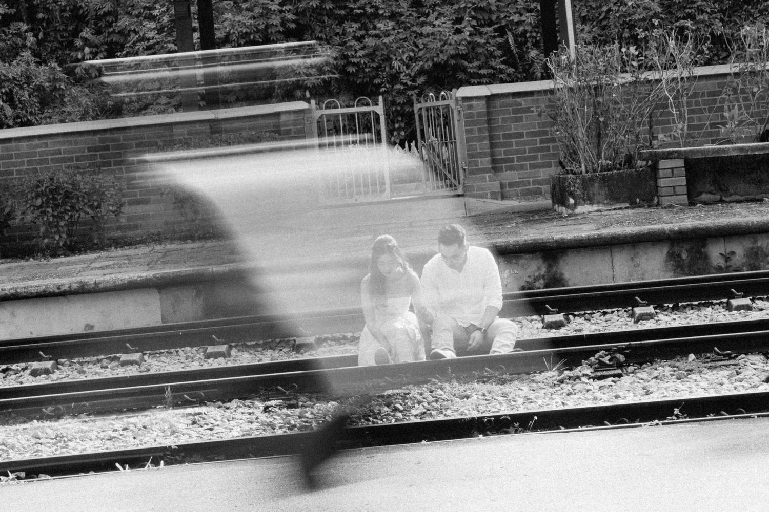 Black and white artistic shot of train tracks with motion blur effect.