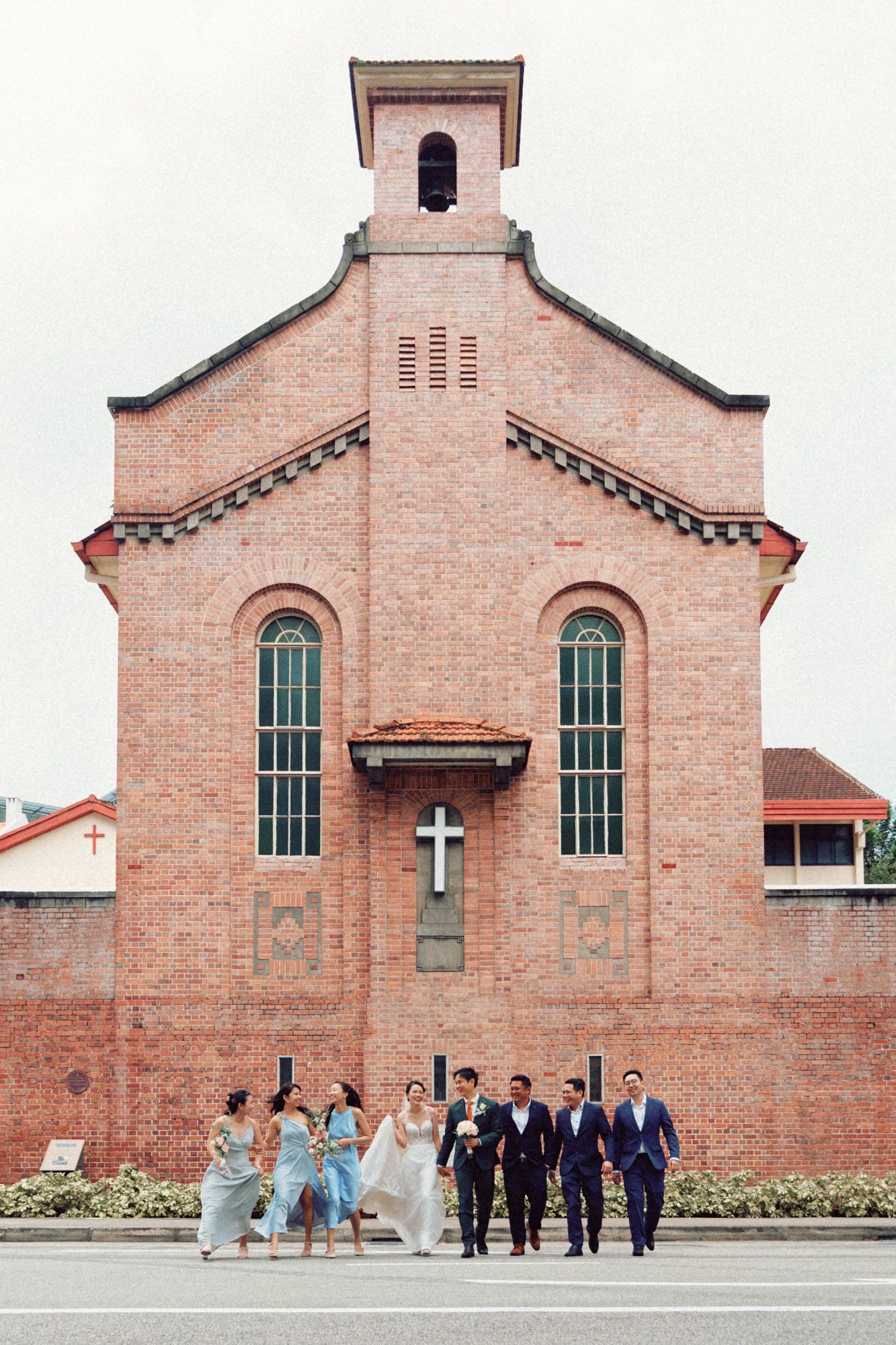 Exterior view of brick church building with arched windows and traditional architecture.