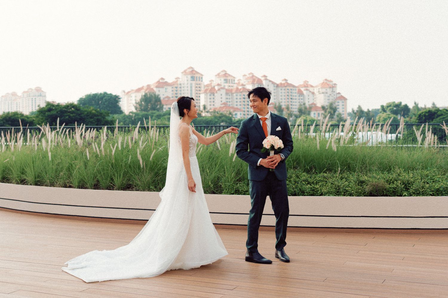 Elegant outdoor wedding ceremony space with modern architecture and natural greenery.