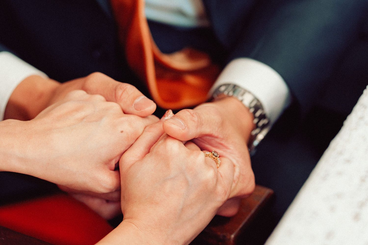 Close-up shots of hands during wedding ring exchange ceremony.