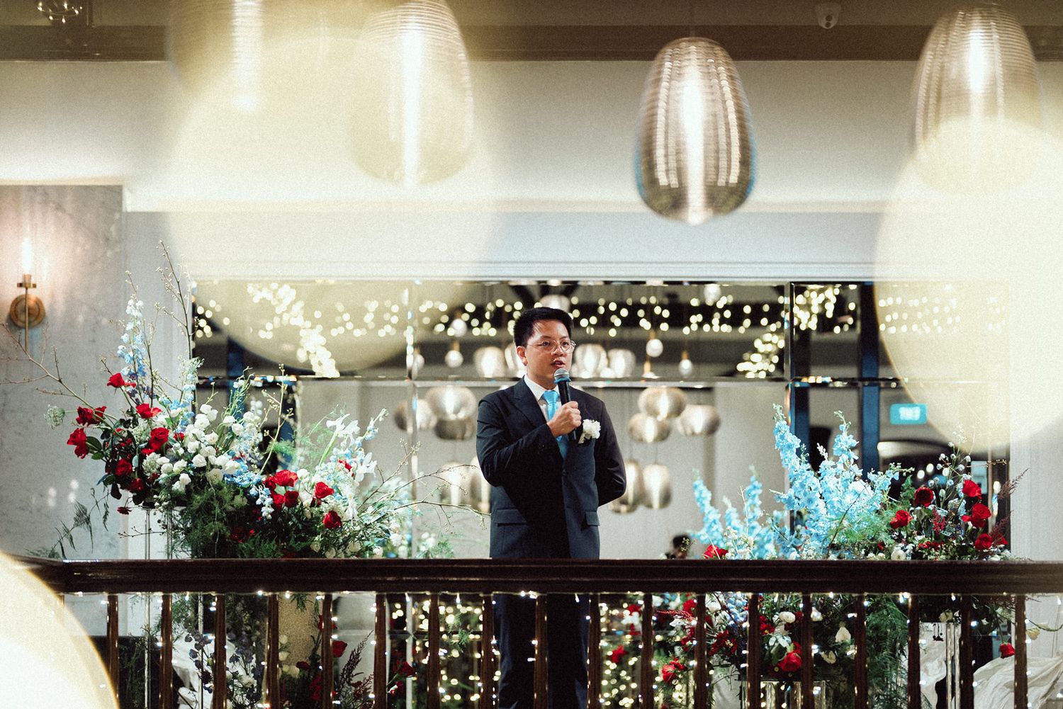 Luxurious indoor wedding reception venue with crystal chandeliers and romantic floral decorations.