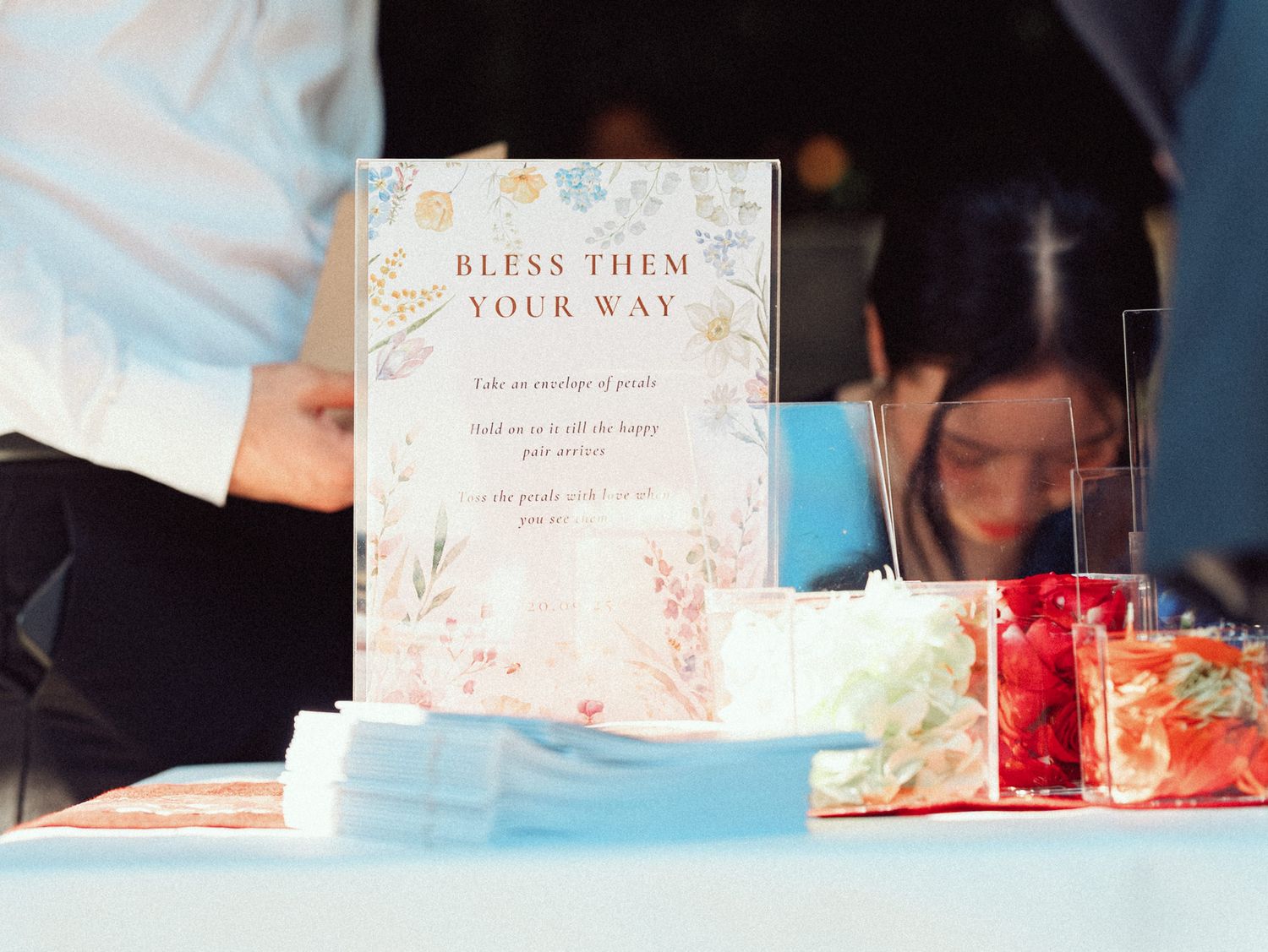 A series of wedding-themed cards and decorations arranged in a horizontal collage with soft lighting and floral elements.