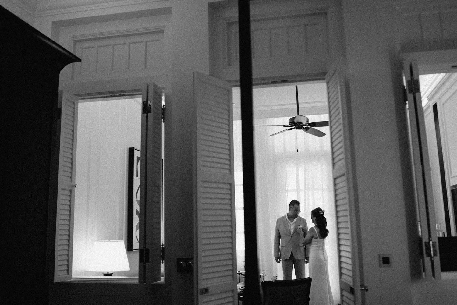 A black and white photo sequence showing a door opening and closing in a bright interior space.