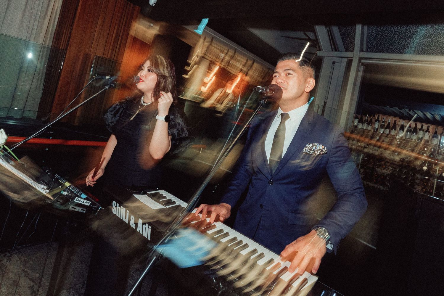 Wedding reception entertainment with DJ equipment and lighting setup.