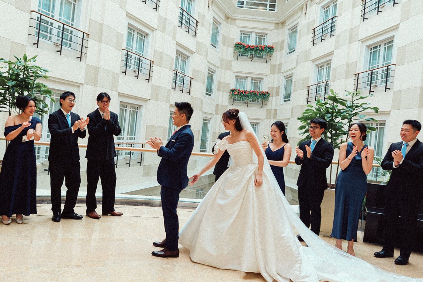 A sequence of wedding ceremony moments captured in a bright indoor venue with white decor and elegant formal attire.