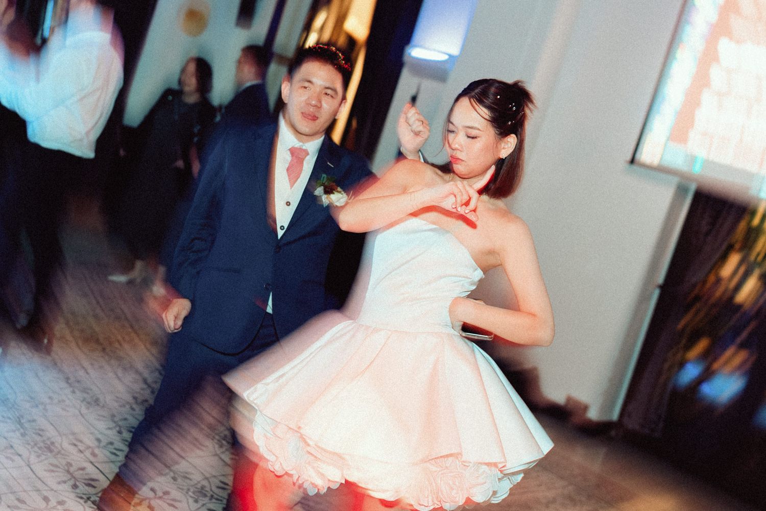 A series of candid wedding reception photos showing couples dancing and celebrating in formal attire.